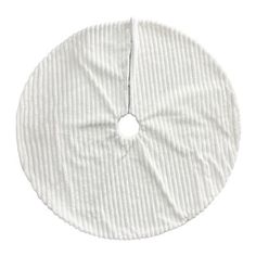 a white round cloth with a hole in the center on a white background, it is made up of thin strips of fabric