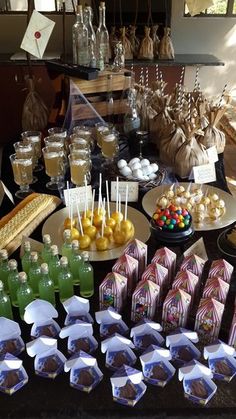 an assortment of desserts and candies on display at a wedding or baby shower