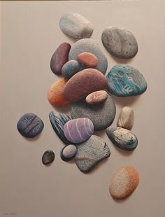 there are many different colored rocks on the wall