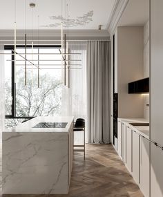 an elegant kitchen with marble counter tops and white cabinets, along with wooden flooring