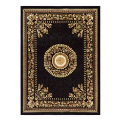 a black rug with an intricate design on the center and gold trimming around it