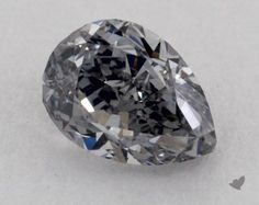 a pear shaped diamond on a white surface