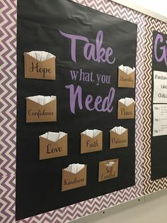 two bulletin boards with words written on them and some paper bags attached to the wall