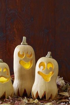 three carved pumpkins with faces on them