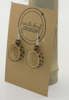 Bamboo earrings made from salvaged bamboo.  This pair features a design that has been burned on the outside of the bamboo ring. Additionally, this pair includes wood beads and silver hardware. The bamboo is sealed with Mod Podge and finished with clear, acrylic spray. Handmade Round Wooden Earrings, Handmade Wooden Round Earrings, Brown Wooden Beads Round Earrings, Round Wooden Earrings As Gift, Round Wooden Earrings For Gifts, Handmade Round Wooden Jewelry, Earthy Wooden Jewelry Gift, Earthy Wood Jewelry Gift, Earthy Wood Jewelry As Gift