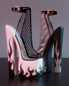 a pair of high heeled shoes that have been designed to look like fire and ice