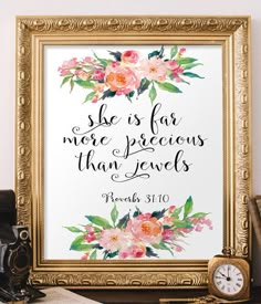 an ornate gold frame with flowers and bible verse on the front, next to a clock