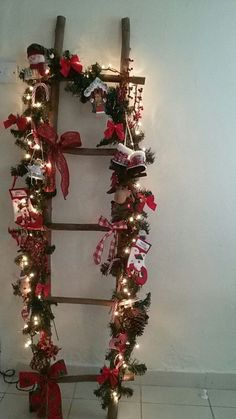 a ladder decorated with christmas decorations and lights