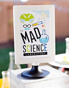 there is a sign that says mad science laboratory on it's postcard holder