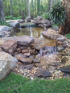 a small pond surrounded by rocks and water