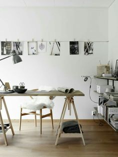 an office with white walls and wooden floors