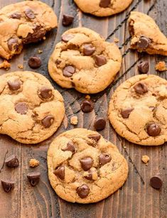 several chocolate chip cookies on a wooden table