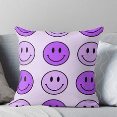 a purple and black smiley face pattern on a white background throw pillow with two pillows