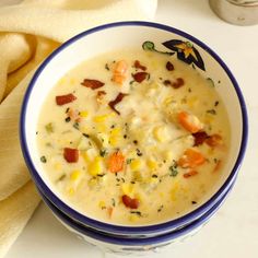 a blue and white bowl filled with soup next to a napkin