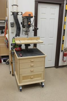 a workbench with a driller on top of it in a room filled with tools