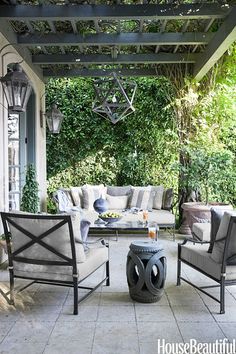 an outdoor living room with furniture and decor