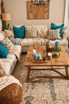 a living room filled with lots of furniture next to a chandelier above a wooden coffee table