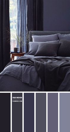 a bedroom with dark blue walls and grey bedding