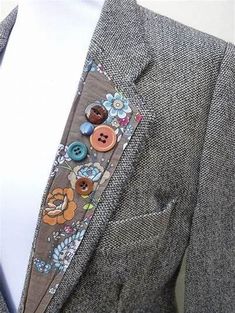 a man wearing a suit with buttons on the lapel