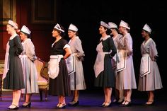 Sets of maid costumes in gray or hunter green with cotton or organdy aprons and hats. Regency Servant, Maid In Manhattan Outfits, 1930s Maid Uniform, Edwardian Maid Uniform, Maid Hat, Broadway Musicals Costumes, Annie Play, Miss Inconspicuous Maid Cleaning, Lorde Hair