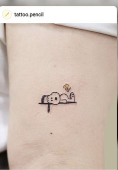 a small tattoo on the side of a woman's stomach, depicting two dogs