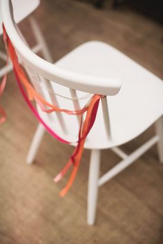 a white chair with red ribbon tied around it