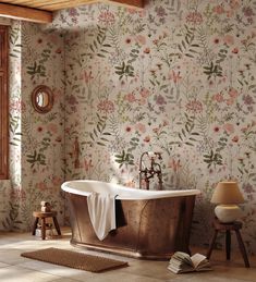 a bath tub sitting in the middle of a bathroom next to a wall with flowers on it