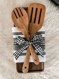 two wooden utensils are wrapped in a bow