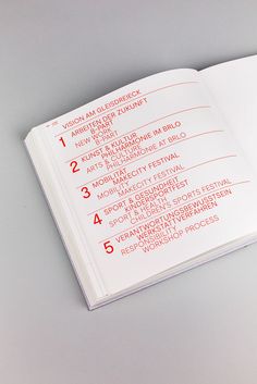 an open book with red numbers on the cover and page numbers in each section,