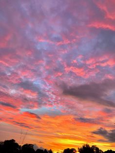 the sky is pink and blue with clouds