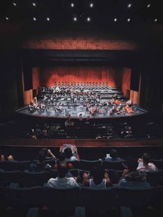 an auditorium filled with people sitting in seats