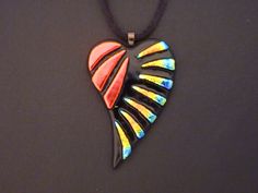 a black necklace with multicolored designs on it