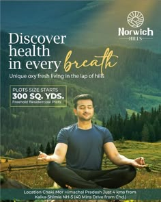 a man meditating in the middle of a field with mountains and trees behind him