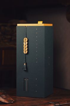 a black box sitting on top of a wooden table