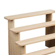 three wooden shelves are stacked on top of each other