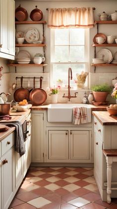 a kitchen filled with lots of pots and pans on the shelves above the sink