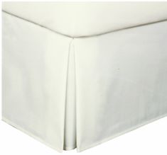 a white bed skirt with pleated edges