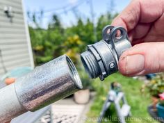 a person is holding an aluminum pipe with one hand