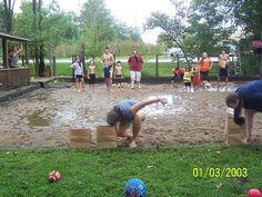 a group of people playing in the mud