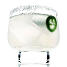 a close up of a drink in a glass on a white background