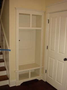 an empty room with stairs leading up to the closet