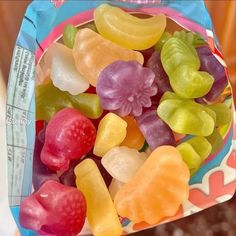 a bag filled with gummy bears sitting on top of a table