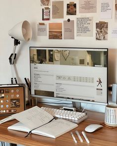 a computer monitor sitting on top of a wooden desk next to a keyboard and mouse