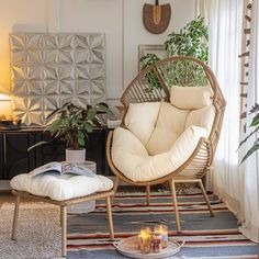 a living room filled with furniture and plants on top of a rug next to a window