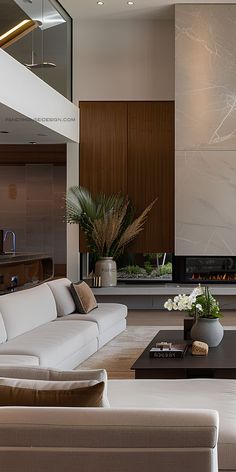 a living room with white couches and a fireplace