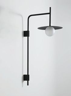 a black lamp is hanging on the wall