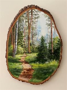 a painting of a path in the woods on a wood slice with grass and trees around it