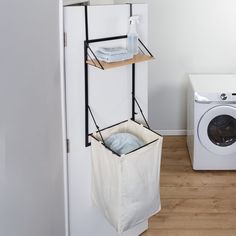 a washer and dryer sitting next to each other in a room with white walls