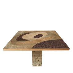 a square wooden table with an abstract design on it