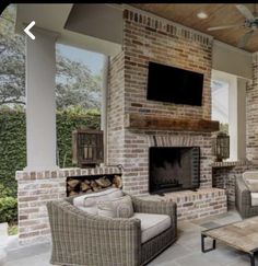 a living room filled with furniture and a flat screen tv mounted to the wall over a fire place